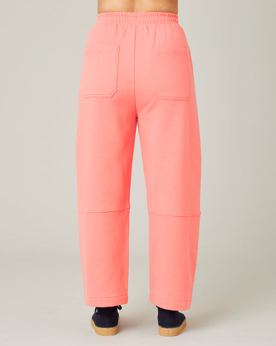 model wears shrimp pink madi trousers 