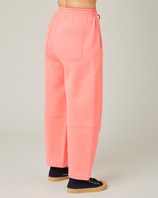 model wears shrimp pink madi trousers 