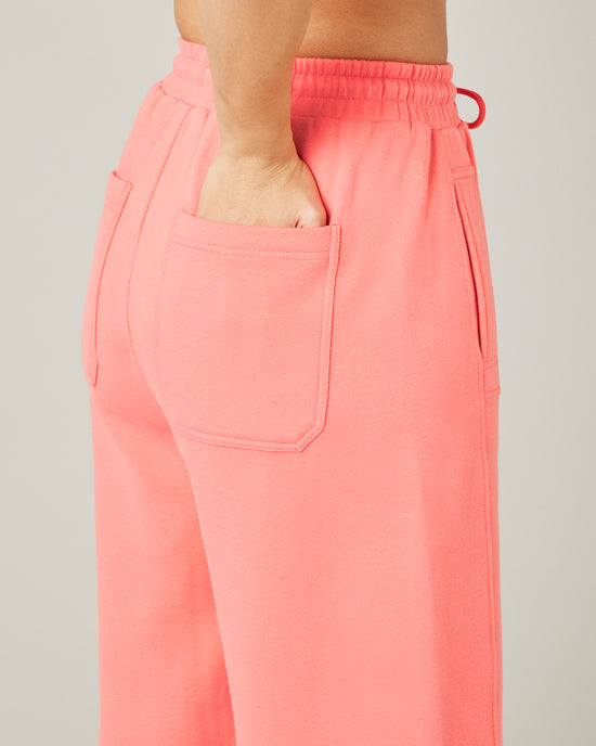 model wears shrimp pink madi trousers 