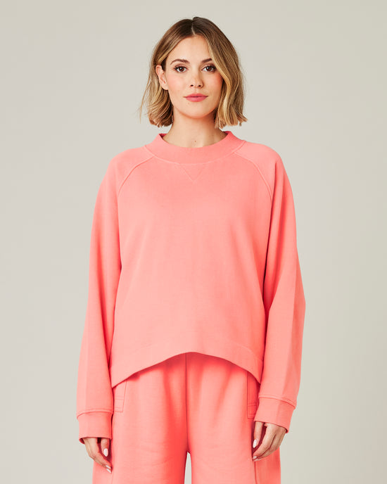 pregnant model wears shrimp pink noa jumper 