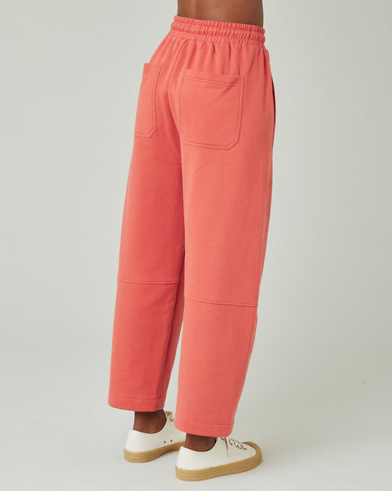 model wears terracotta jersey madi trousers right