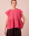 model wears nola raspberry stripe seersucker top
