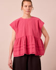 model wears nola raspberry stripe seersucker top