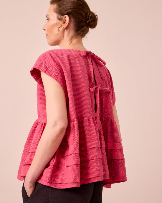 model wears nola raspberry stripe seersucker top