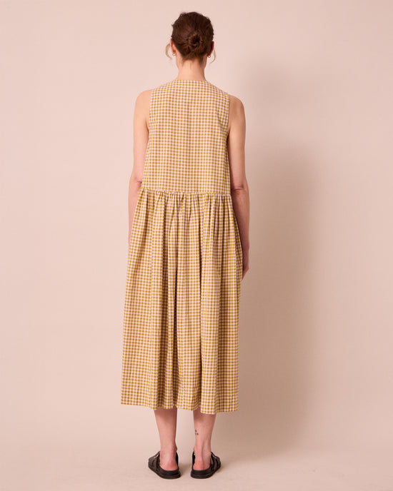 model wears olwen garden gingham cotton linen dress