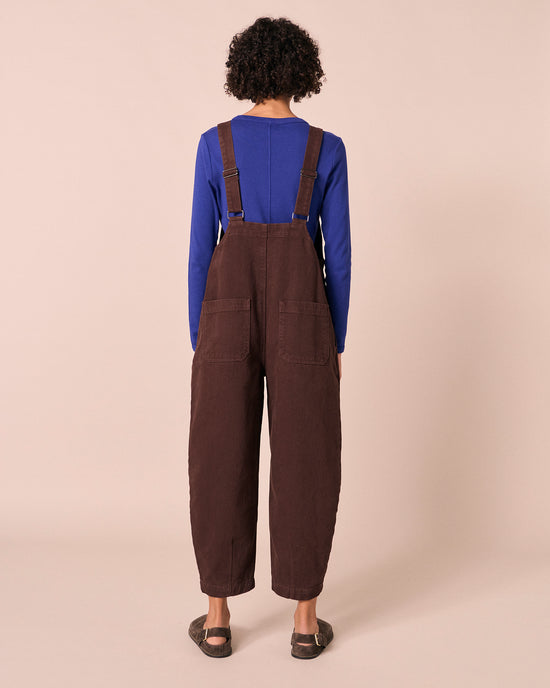 model wears ophelia cedar brown denim jumpsuit