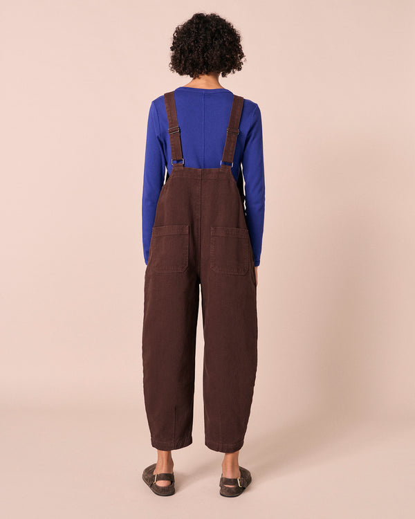 model wears ophelia cedar brown denim jumpsuit