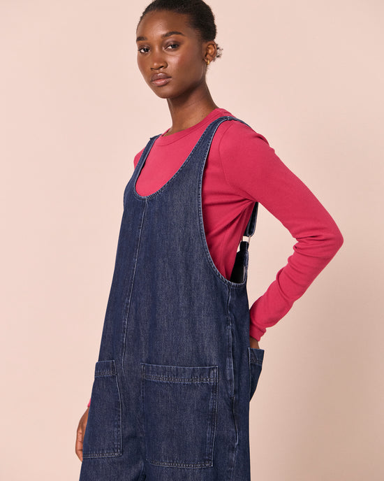 model wears ophelia dark wash denim jumpsuit