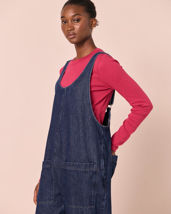 model wears ophelia dark wash denim jumpsuit