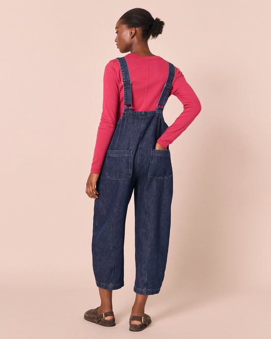 model wears ophelia dark wash denim jumpsuit