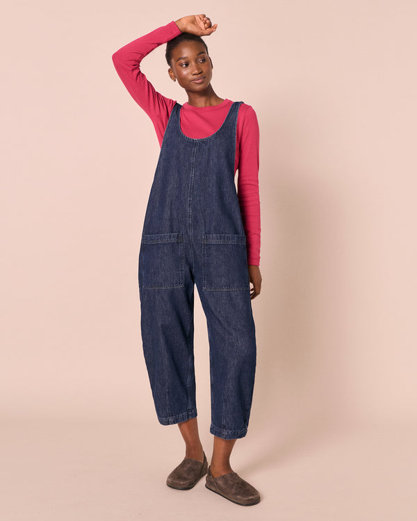 model wears ophelia dark wash denim jumpsuit