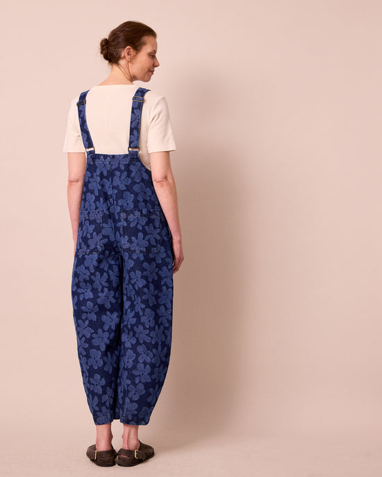 model wears ophelia pressed flower print denim jumpsuit
