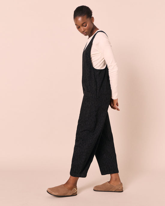 model wears ophelia black leopard denim jumpsuit