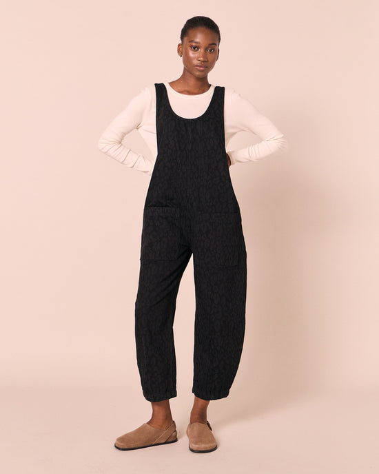 model wears ophelia black leopard denim jumpsuit