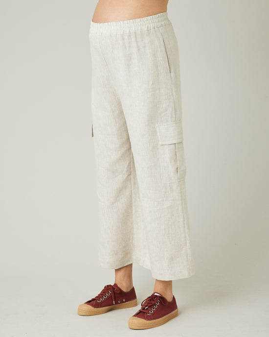 model wears natural linen orla trousers left