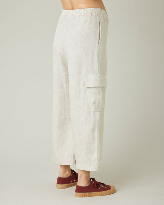 model wears natural linen orla trousers right