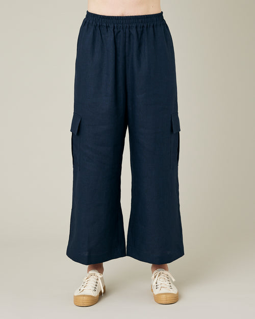 model wears navy linen orla trousers front