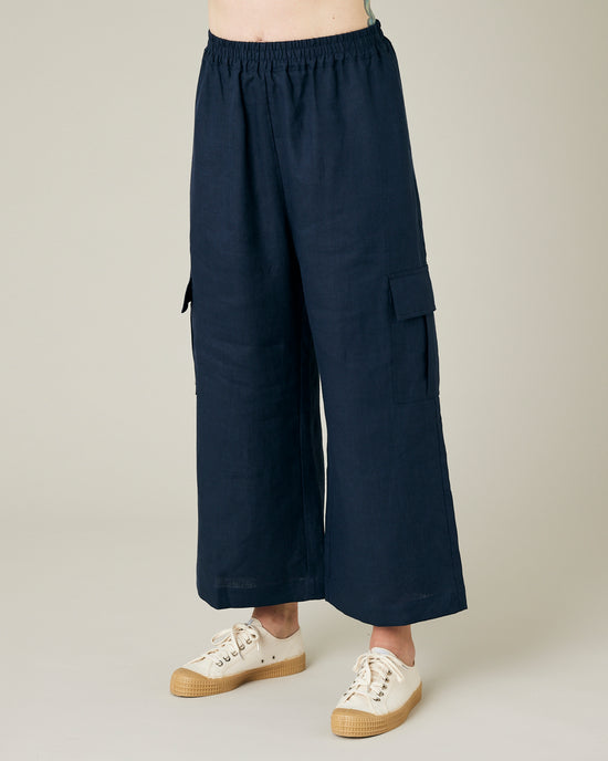 model wears navy linen orla trousers left