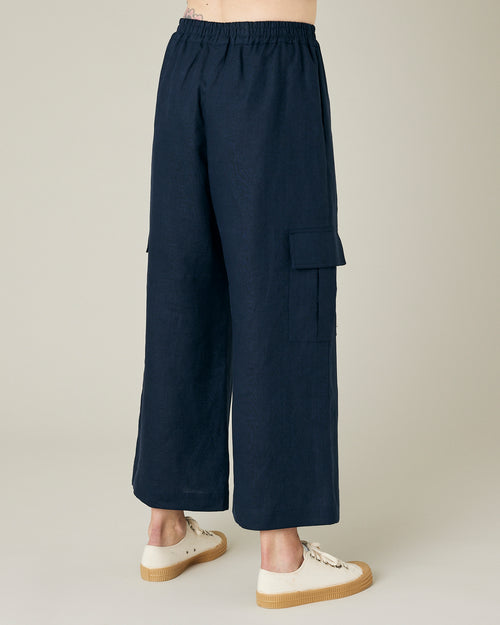 model wears navy linen orla trousers right