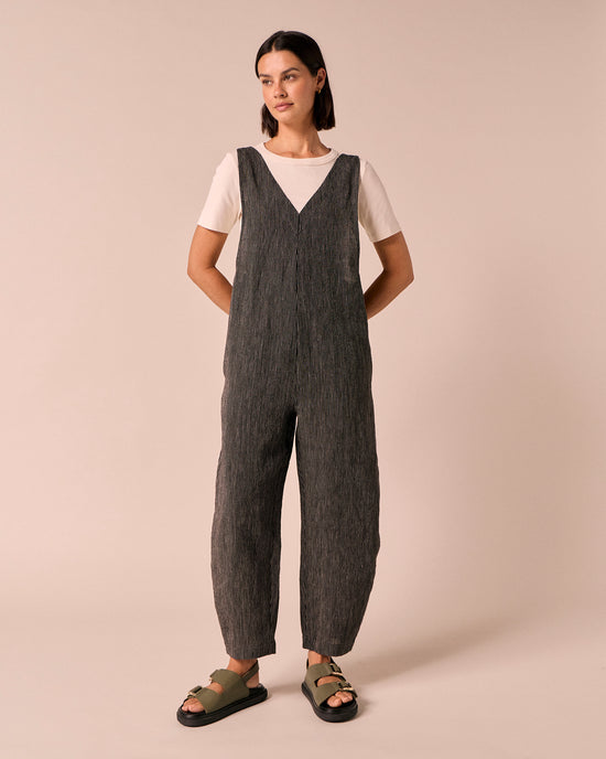 model wears ottie black and ecru pencil stripe linen jumpsuit