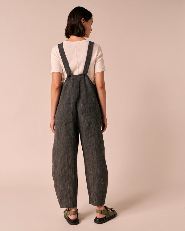 model wears ottie black and ecru pencil stripe linen jumpsuit