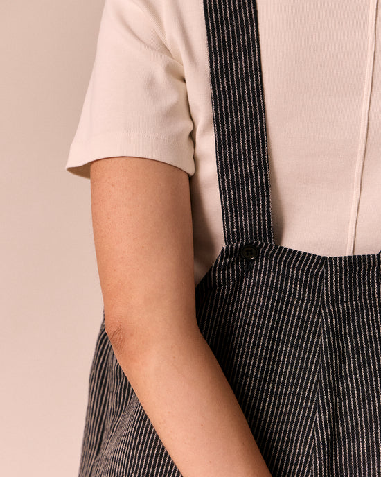 model wears ottie black and ecru pencil stripe linen jumpsuit