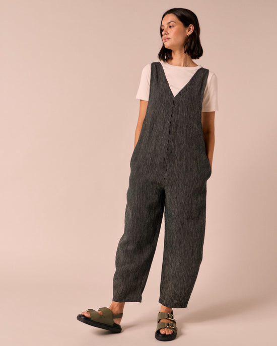 model wears ottie black and ecru pencil stripe linen jumpsuit