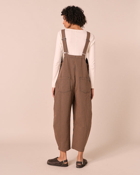 model wears ottie nutmeg pinstripe denim jumpsuit