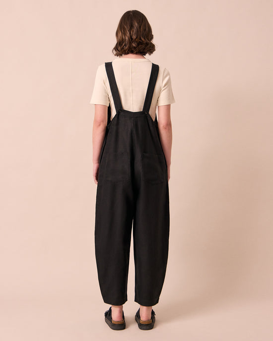 model wears ottie black linen jumpsuit
