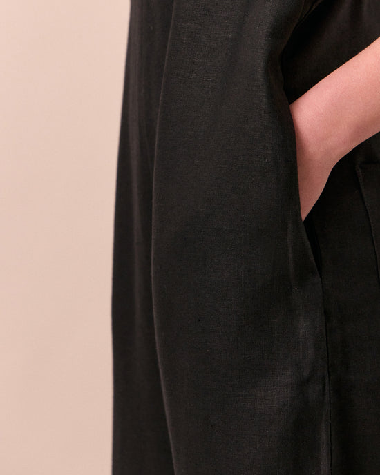 model wears ottie black linen jumpsuit