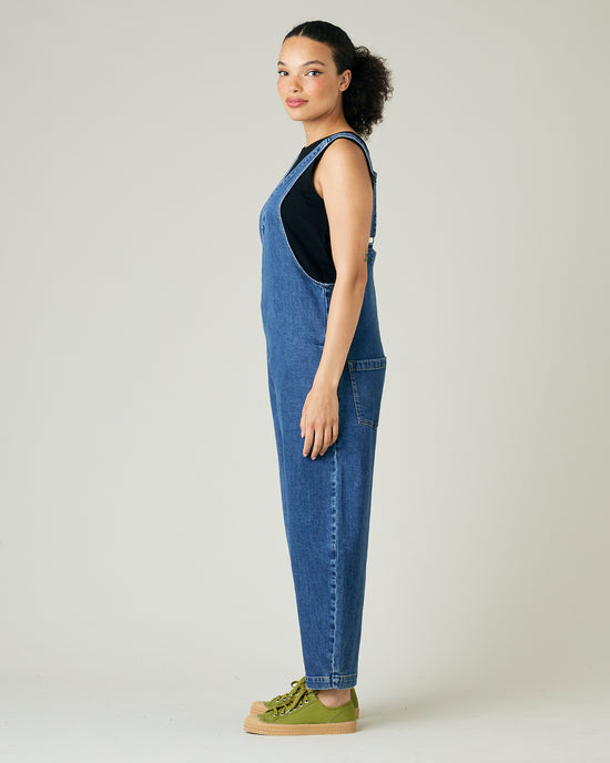 model wears mid blue denim ottie jumpsuit