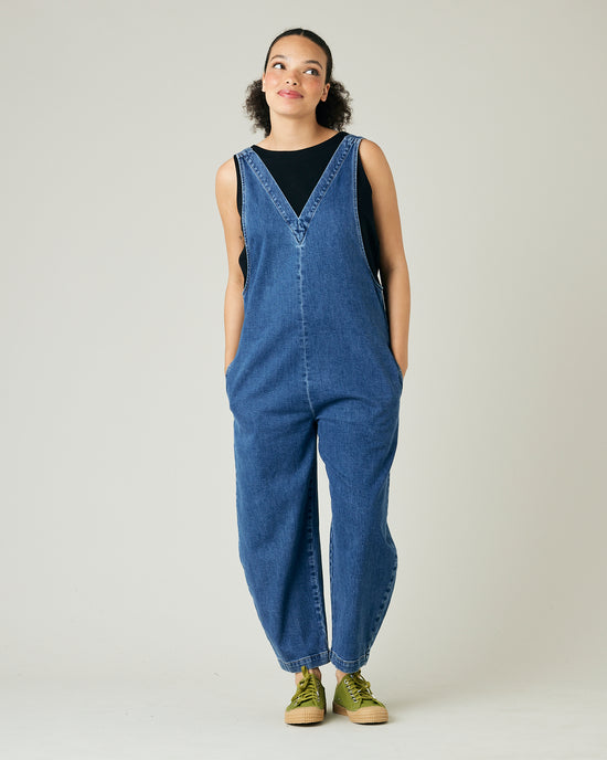 model wears mid blue denim ottie jumpsuit