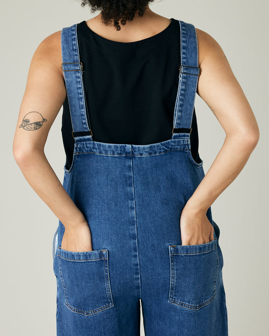 model wears mid blue denim ottie jumpsuit