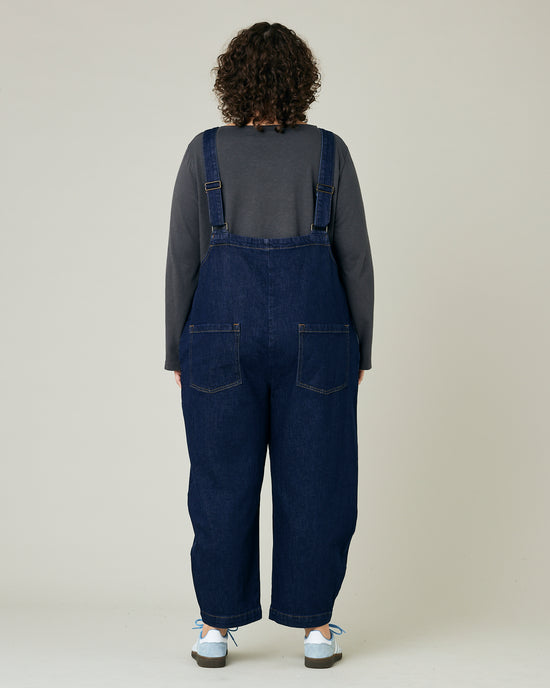 model wears dark wash ottie jumpsuit