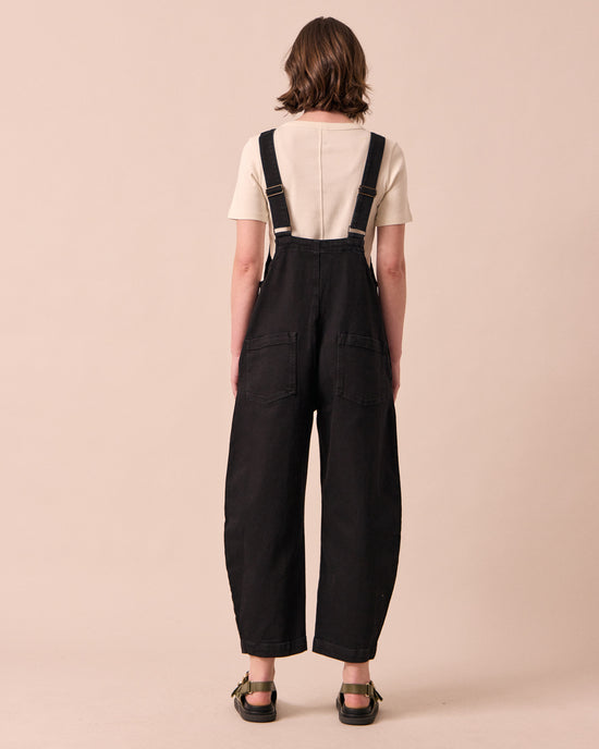 model wears ottie black denim jumpsuit