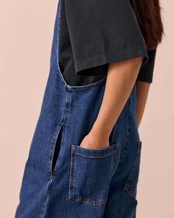 model wears ottie mid blue denim jumpsuit