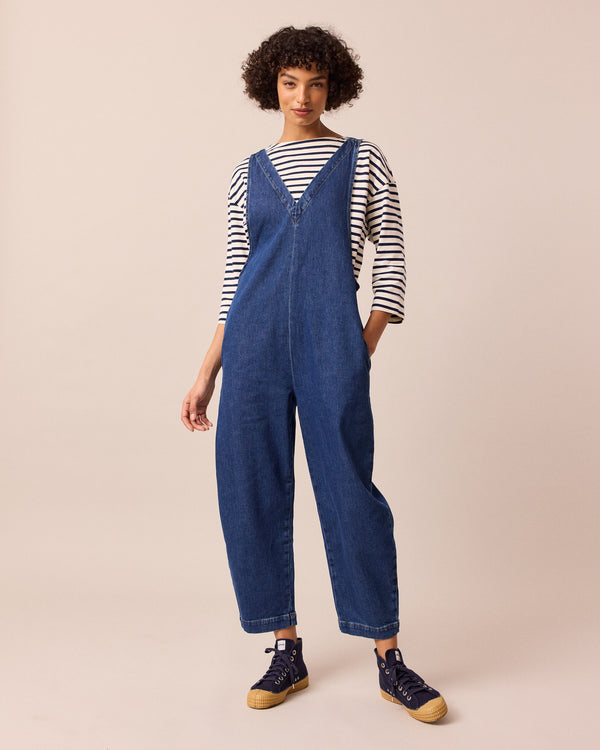 model wears ottie mid blue denim jumpsuit