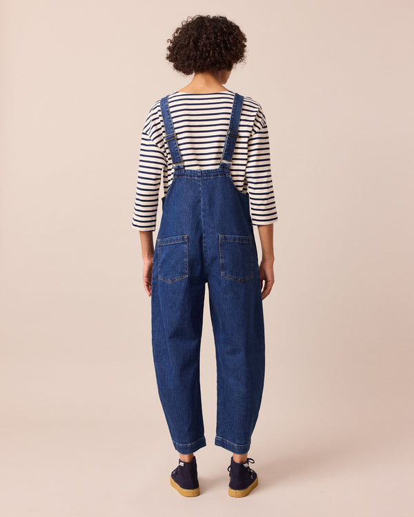 model wears ottie mid blue denim jumpsuit