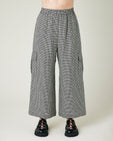 model wears black and stone micro gingham orla trousers front