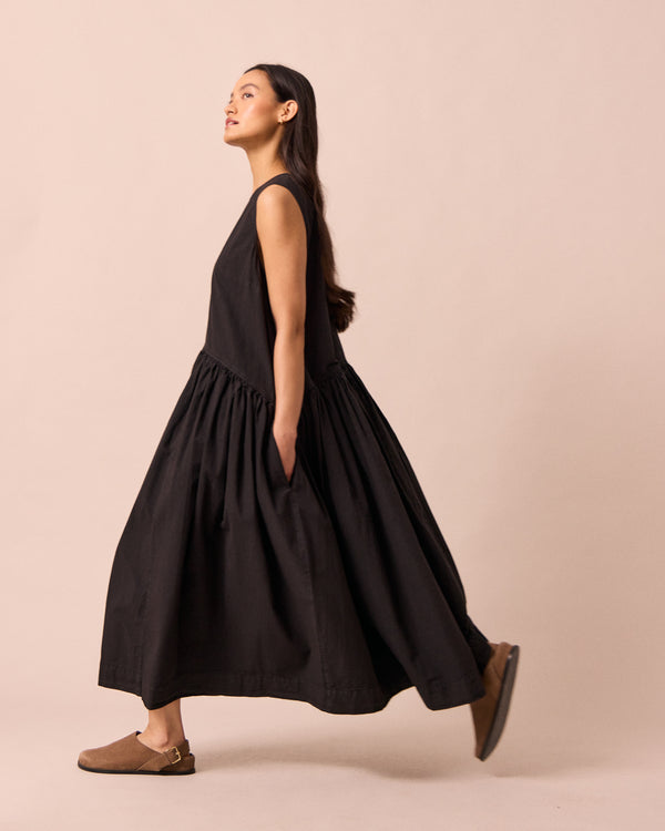 model wears gina black cotton poplin dress