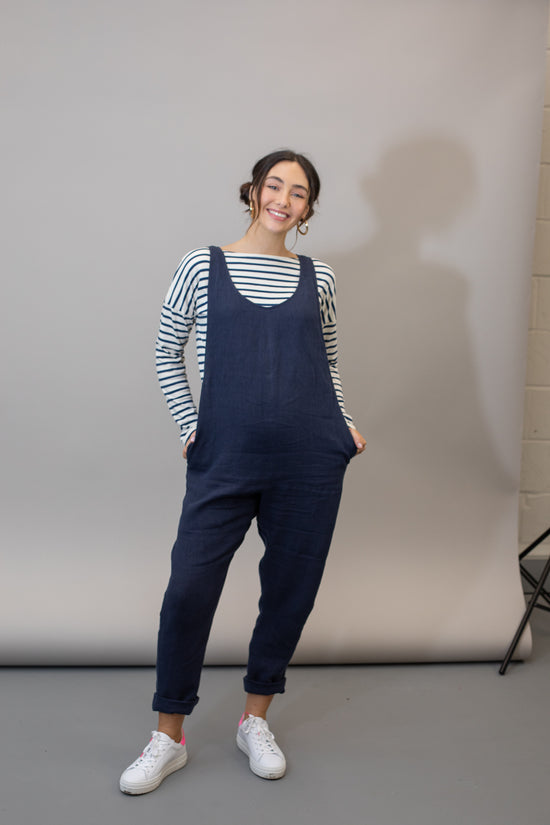 pregnant model wears navy linen laura jumpsuit