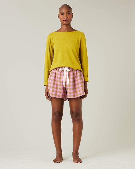 model wears pink and green check bed shorts