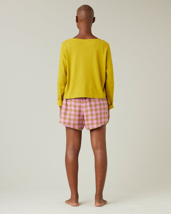 model wears pink and green check bed shorts