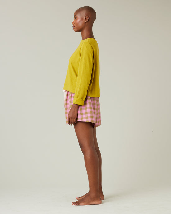 model wears pink and green check bed shorts