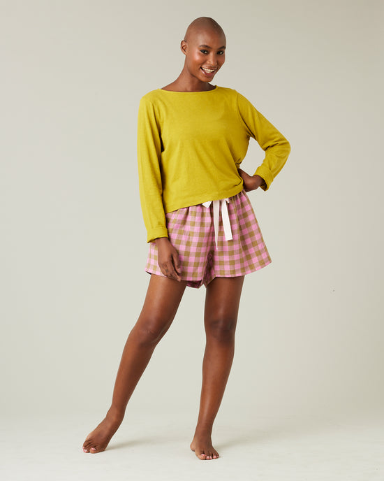 model wears pink and green check bed shorts