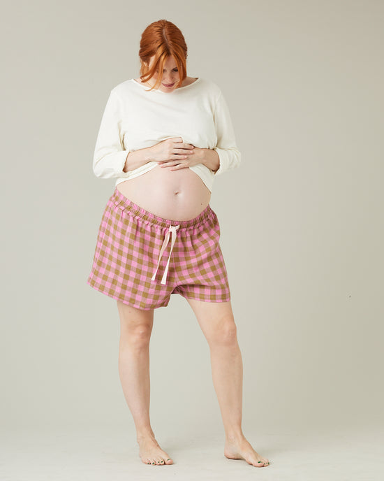 pregnant model wears pink and green check bed shorts