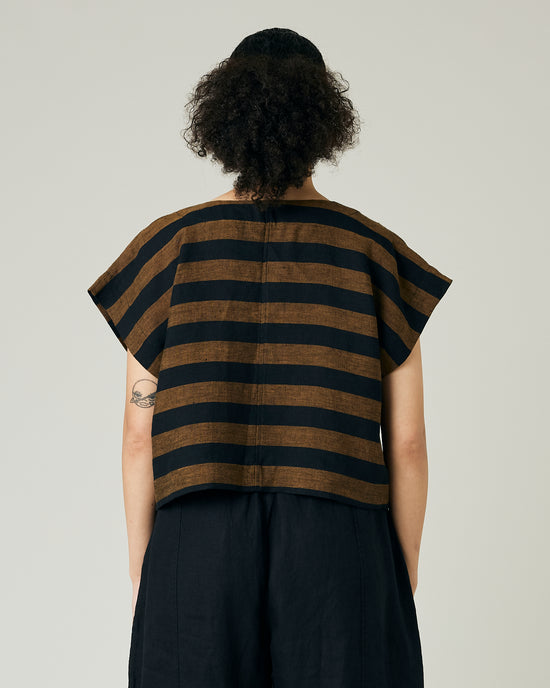 model wears rust stripe linen polly top