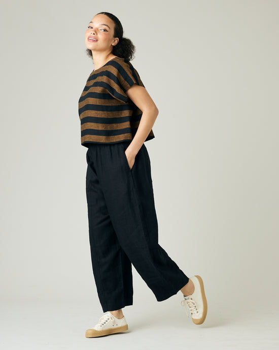 model wears rust stripe linen polly top