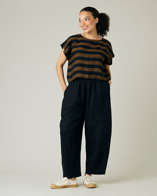 model wears rust stripe linen polly top