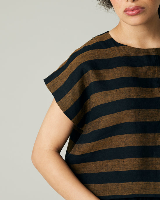 model wears rust stripe linen polly top